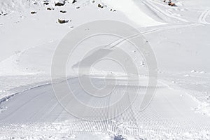 Fresh snow groomer tracks on a ski piste