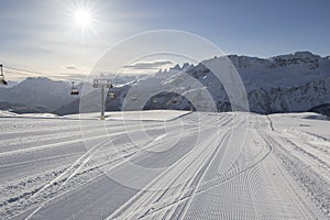 Fresh snow groomer tracks on a ski piste