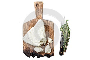 Fresh Soft goat cheese on a cutting board with thyme. Isolated on white background, top view.