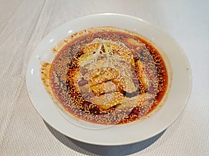 fresh spicy and chilly chicken with sesame in the red oil