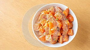 Fresh spicy salmon and rice on a wooden table