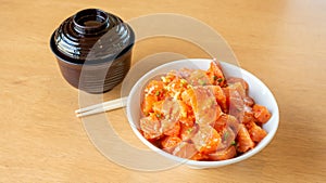 Fresh spicy salmon and rice on a wooden table