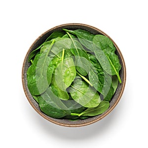 Fresh spinach with drops in a bowl isolated on white background. Top view.