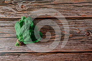 Fresh Spinach Leaves Bouquet . Wooden background. Copy space. Vegetarian diet concept. Green vegetables. Healthly food