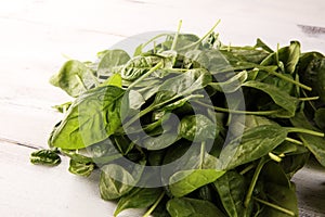 Fresh spinach leaves on rustic wooden table. Healthy salad concept