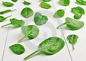 Fresh spinach leaves on white background. Healthy vegan food concept. Eco-conscious vegan lifstyle.