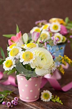 Fresh spring flowers in little vases