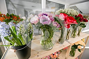Fresh spring flowers in refrigerator for flowers in flower shop. Bouquets on shelf, florist business.