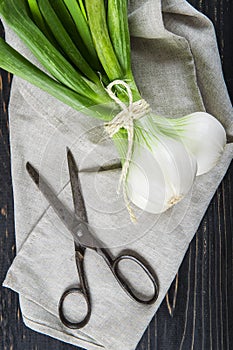 Fresh spring onions and old scissors