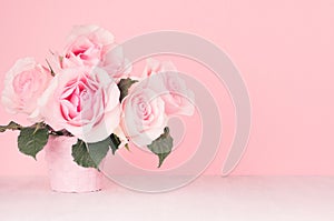 Fresh spring romance roses bouquet in pastel pink color on white wood board, copy space.