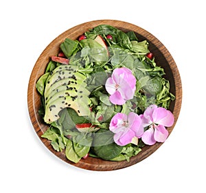 Fresh spring salad with flowers in bowl isolated on white, top view