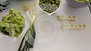 Fresh spring vegetables on white background, text ` Hello spring`