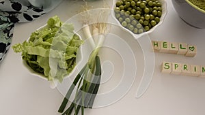 Fresh spring vegetables on white background, text ` Hello spring`