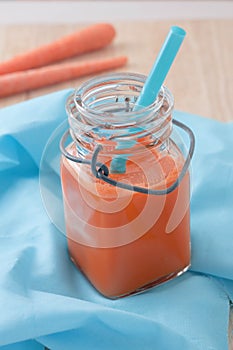 Fresh squeezed organic carrot juice in clear glass