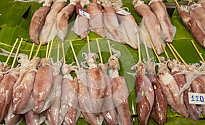 Fresh squid skewers on banana leaves sold in the market