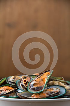 Fresh steamed mussels in white bowl