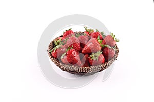 Fresh strawberries in a basket against a white background