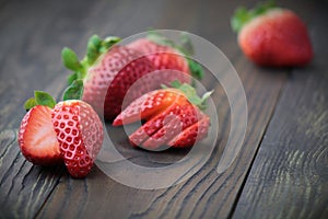 Fresh strawberries on black wooden table