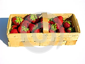 Fresh strawberries in a chip basket against a white background