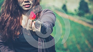 Fresh strawberries closeup. holding strawberry in hands