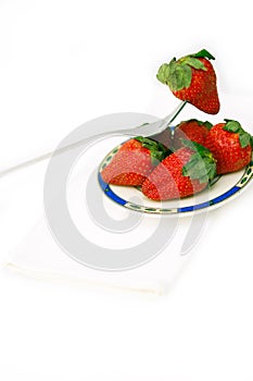 Fresh strawberries dish over white