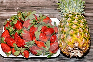 fresh strawberries fruit, the garden strawberry is a widely grown hybrid species of the genus Fragaria ananassa and Pineapple