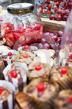 Fresh strawberries, grapes and cherry topped cupcakes