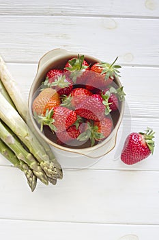 Fresh strawberries and Green Asparagus on white