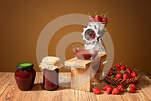 Fresh strawberries and jam in a jar