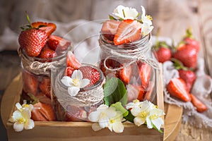 Fresh strawberries in jars