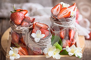 Fresh strawberries in jars