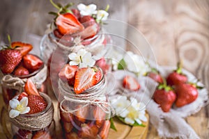 Fresh strawberries in jars