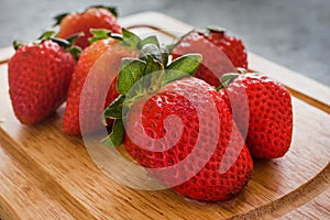 Fresh strawberries juicy on wooden table photo