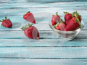 Fresh strawberries on an old wooden surface