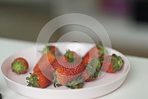 Fresh strawberries on white plate