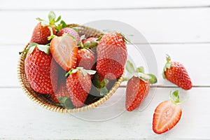 Fresh strawberries on wooden background - ripe red strawberry picking in basket