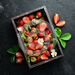 Fresh strawberries in a wooden box. Berries Top view.