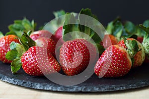 Fresh strawberry on black slate board. Healthy eating