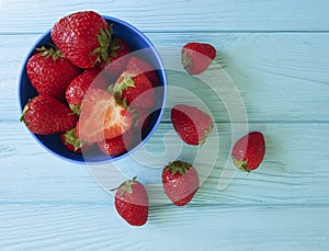 Fresh strawberry dish on a blue wooden background