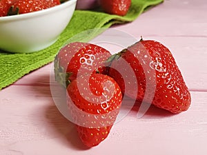 Fresh strawberry natural dish towel on a pink wooden background