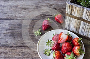 Fresh strawberry in dish on the wood table