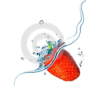 Fresh strawberry dropped into water