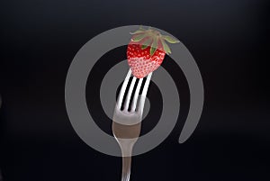 Fresh strawberry on fork