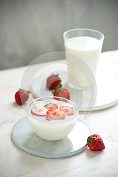 Fresh strawberry on a glass with dessert yogurt and strawberry  on white background
