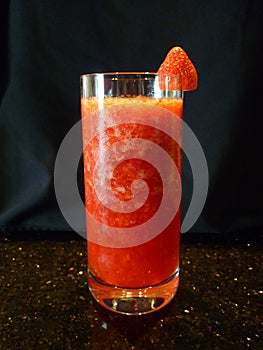 Fresh strawberry juice isolated on black baground