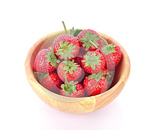 Fresh strawberry in a wooden bowl isolated on white background