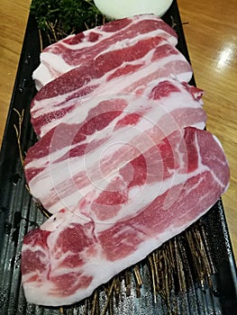 Fresh streaky pork slice serving on the tray, pork belly slice