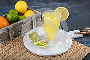 Fresh summer cocktail with lemon, selective focus image. Lemonade. Drink with fresh lemons. Lemon cocktail with juice