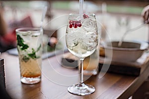 Fresh summer cocktails with bubbles, lime, mint and red berries