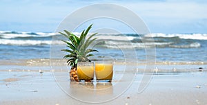 Fresh summer drink with pineapple on a beautiful beach